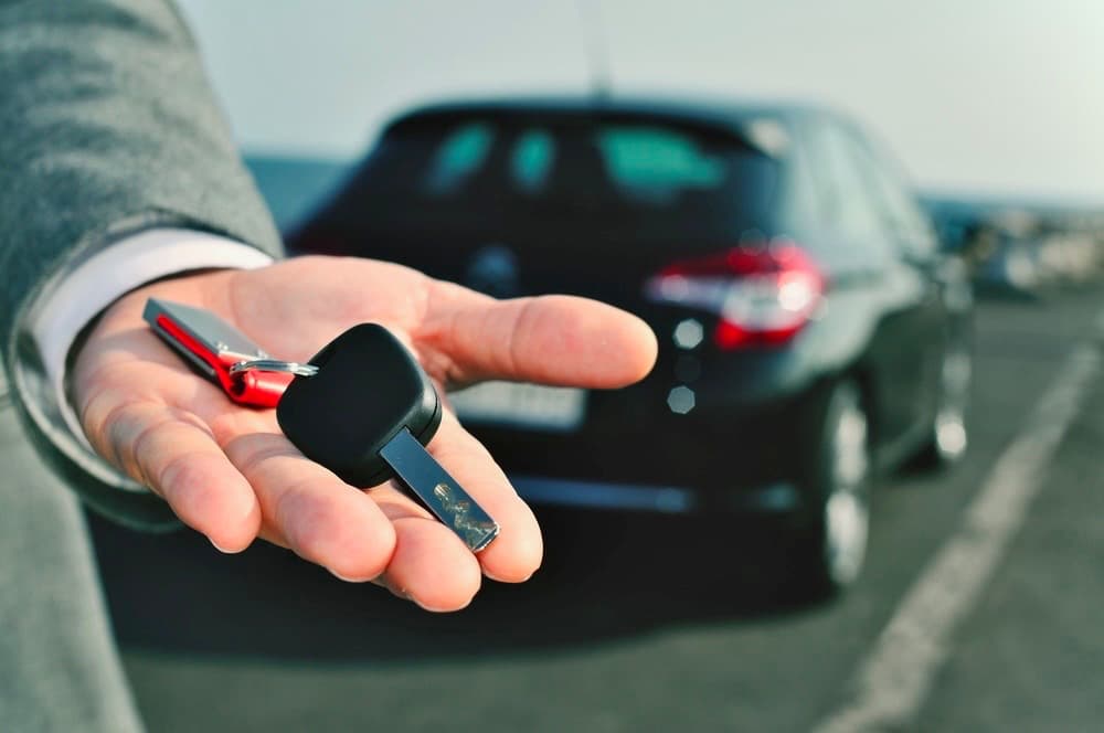 Car keys handed back to the owner in front of their car